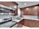 Close up of a kitchen with stainless steel appliances, backsplash, and granite countertops at 206 4Th Nw Ave, Ruskin, FL 33570