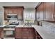 Updated kitchen features stainless steel appliances, backsplash, and granite countertops at 206 4Th Nw Ave, Ruskin, FL 33570