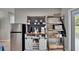 Bright open kitchen with stainless steel refrigerator and coffee bar with stylish shelving at 206 4Th Nw Ave, Ruskin, FL 33570