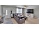 Cozy living room features hardwood floors, a leather sofa, and a large screen TV at 206 4Th Nw Ave, Ruskin, FL 33570
