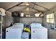 Functional storage shed interior with laundry and storage, maximizing organization and space efficiency at 206 4Th Nw Ave, Ruskin, FL 33570