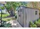 Outdoor storage shed featuring durable siding and providing storage for tools and equipment with double door entry at 206 4Th Nw Ave, Ruskin, FL 33570