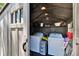 Shed's interior showing laundry machines and shelving, maximizing storage space for organization in the backyard at 206 4Th Nw Ave, Ruskin, FL 33570