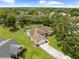 Aerial view shows this home's manicured lawn and it's location among mature trees at 206 Forest Wood Ct, Spring Hill, FL 34609