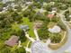 Aerial view of a neighborhood with mature trees and winding streets at 206 Forest Wood Ct, Spring Hill, FL 34609