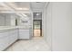 Clean bathroom showcases dual sinks, a walk-in closet and open access to the outdoor patio at 206 Forest Wood Ct, Spring Hill, FL 34609