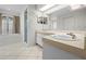Well-lit bathroom showcases dual sinks, spacious vanity, walk-in shower, and soaking tub at 206 Forest Wood Ct, Spring Hill, FL 34609