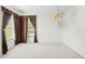 Bright bedroom showcasing neutral carpet, corner windows with dark curtains, and vintage lighting at 206 Forest Wood Ct, Spring Hill, FL 34609