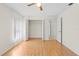 Bright bedroom featuring hardwood floors, closet, and natural light from windows, and a ceiling fan at 206 Forest Wood Ct, Spring Hill, FL 34609