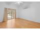 Bright bedroom with hardwood floors, a high ceiling, and sliding glass doors that lead outside at 206 Forest Wood Ct, Spring Hill, FL 34609