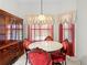 Elegant dining area featuring marble table, plush chairs, and a vintage hutch at 206 Forest Wood Ct, Spring Hill, FL 34609