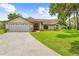 Charming single-story home featuring a well-maintained lawn and an attached two-car garage at 206 Forest Wood Ct, Spring Hill, FL 34609