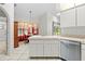 Bright kitchen features white cabinetry, stainless steel appliances, and a view into the dining area at 206 Forest Wood Ct, Spring Hill, FL 34609