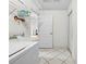 This laundry room includes tile flooring, overhead storage, and washer/dryer connections for added convenience at 206 Forest Wood Ct, Spring Hill, FL 34609