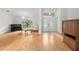 Open living room with hardwood floors, piano, and double door entry at 206 Forest Wood Ct, Spring Hill, FL 34609