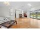Bright living room with hardwood floors, open layout, and a view of the outdoor pool area at 206 Forest Wood Ct, Spring Hill, FL 34609
