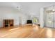 Bright living room showcasing hardwood floors, a piano, and large windows at 206 Forest Wood Ct, Spring Hill, FL 34609