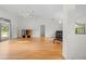 Spacious living room featuring vaulted ceilings, wood flooring, and ample natural light at 206 Forest Wood Ct, Spring Hill, FL 34609