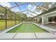 Inviting screened-in pool area with an extended patio and lush backyard at 206 Forest Wood Ct, Spring Hill, FL 34609