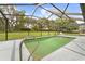 Inviting screened-in pool area with a view of the lush backyard and blue skies at 206 Forest Wood Ct, Spring Hill, FL 34609
