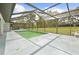 Enjoy the refreshing screened-in pool with views of the expansive backyard and sky at 206 Forest Wood Ct, Spring Hill, FL 34609