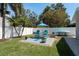 Inviting backyard featuring a fire pit area with Adirondack chairs, perfect for relaxing outdoors at 2271 Carolyn Dr, Dunedin, FL 34698
