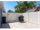 Fenced backyard with grill and patio, offering a private outdoor space with room to entertain at 2271 Carolyn Dr, Dunedin, FL 34698