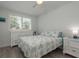 Bright bedroom with a comfortable bed, dresser, ceiling fan, and ample natural light at 2271 Carolyn Dr, Dunedin, FL 34698