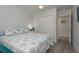 Bright bedroom with coastal-themed bedding, closet, and wood-look flooring for a serene retreat at 2271 Carolyn Dr, Dunedin, FL 34698