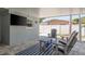 Relaxing covered patio area with comfortable Adirondack chairs, perfect for enjoying the outdoor space at 2271 Carolyn Dr, Dunedin, FL 34698