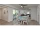 Cozy dining area adjacent to living room with sliding glass door to outside at 2271 Carolyn Dr, Dunedin, FL 34698