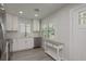 Bright kitchen featuring stainless steel appliances, white cabinets, and modern countertops at 2271 Carolyn Dr, Dunedin, FL 34698