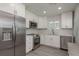 Modern kitchen featuring stainless steel appliances, white cabinets, and ample counter space at 2271 Carolyn Dr, Dunedin, FL 34698