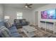 Comfortable living room with stylish sofas, a decorative coffee table, and a mounted TV at 2271 Carolyn Dr, Dunedin, FL 34698