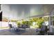 Cozy, covered patio space featuring pavers, comfortable seating and view to the private backyard at 2271 Carolyn Dr, Dunedin, FL 34698