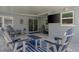 Comfortable covered patio with outdoor TV and plenty of seating for relaxing and enjoying the outdoors at 2271 Carolyn Dr, Dunedin, FL 34698