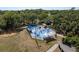 Overhead view of a vibrant splash pad with water features, shaded seating, and a secure fenced perimeter for play at 2271 Carolyn Dr, Dunedin, FL 34698