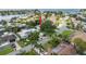 Aerial view showcasing the neighborhood, green trees, and nearby waterfront at 2334 Tropical Shores Se Dr, St Petersburg, FL 33705