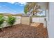 A shed is in the backyard with a white fence and some sparse tropical landscaping at 2334 Tropical Shores Se Dr, St Petersburg, FL 33705