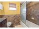 Bathroom featuring earth-tone tiles in the shower with dark wood cabinets at 2334 Tropical Shores Se Dr, St Petersburg, FL 33705