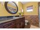 Bathroom featuring dark wood cabinets, earth-tone tiles and decorative mirror at 2334 Tropical Shores Se Dr, St Petersburg, FL 33705