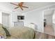 Bright bedroom featuring a ceiling fan, a TV and light wood-look flooring at 2334 Tropical Shores Se Dr, St Petersburg, FL 33705