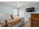 Bedroom featuring a ceiling fan, a TV and light wood-look flooring at 2334 Tropical Shores Se Dr, St Petersburg, FL 33705
