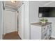 Bedroom view of closet space, TV and a 5-drawer chest with light wood-look flooring at 2334 Tropical Shores Se Dr, St Petersburg, FL 33705