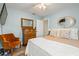 Cozy bedroom with wooden floors, a ceiling fan and a vintage-style dresser and comfy chair at 2334 Tropical Shores Se Dr, St Petersburg, FL 33705