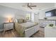 Bright bedroom featuring a ceiling fan, a TV and light wood-look flooring at 2334 Tropical Shores Se Dr, St Petersburg, FL 33705