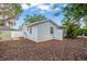 A view of the side yard showing fencing, white exterior paint, and a shed at 2334 Tropical Shores Se Dr, St Petersburg, FL 33705