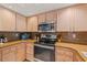 Modern kitchen boasting stainless steel appliances, granite counters, and light wood cabinets at 2334 Tropical Shores Se Dr, St Petersburg, FL 33705