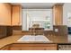 Kitchen view of stainless steel faucet and light colored wood cabinets with granite countertops and a pass through window at 2334 Tropical Shores Se Dr, St Petersburg, FL 33705
