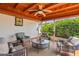 Relaxing lanai with decorative wood ceiling, comfortable seating, and views of the lush backyard at 2334 Tropical Shores Se Dr, St Petersburg, FL 33705